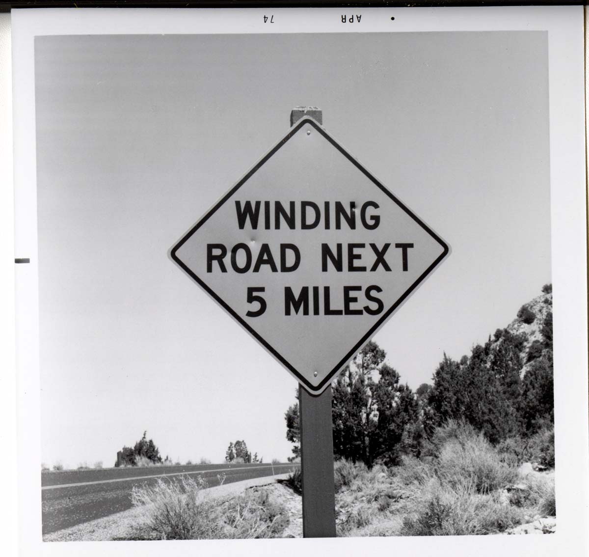 Road sign reading 'Winding Road Next 5 Miles' in Kolob Canyon.