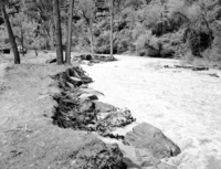 The Virgin River near Temple of Sinawava at high flood stage. Control work necessary and carried out by dumping large boulders into the river (revetment work). Exhibit #5.