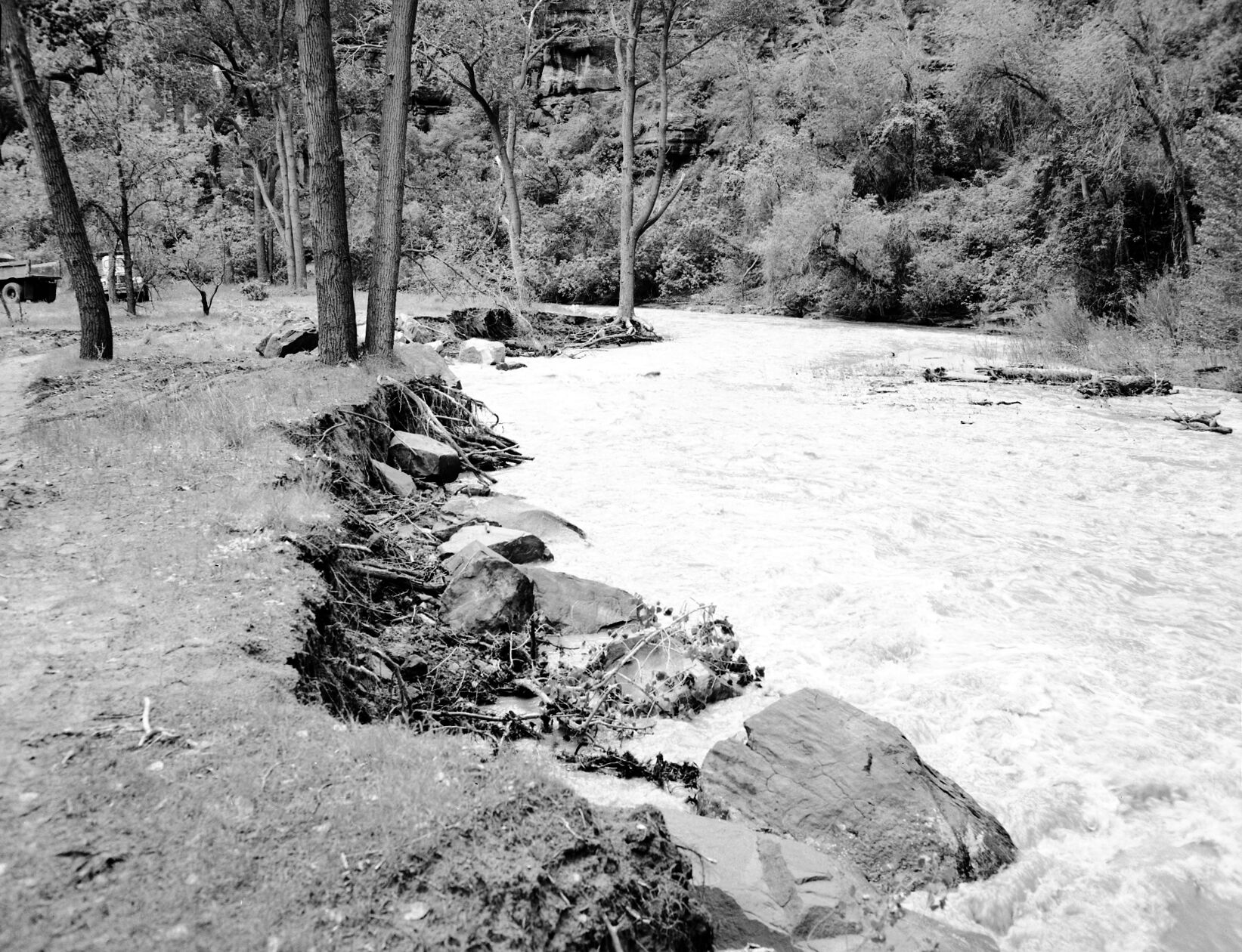 The Virgin River near Temple of Sinawava at high flood stage. Control work necessary and carried out by dumping large boulders into the river (revetment work). Exhibit #5.