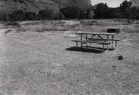 Picnic table and grill at a camp site in the Watchman Campground.