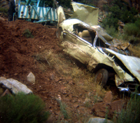 Color photos of park personnel removing a car from the flood waters of the 1975 flood.