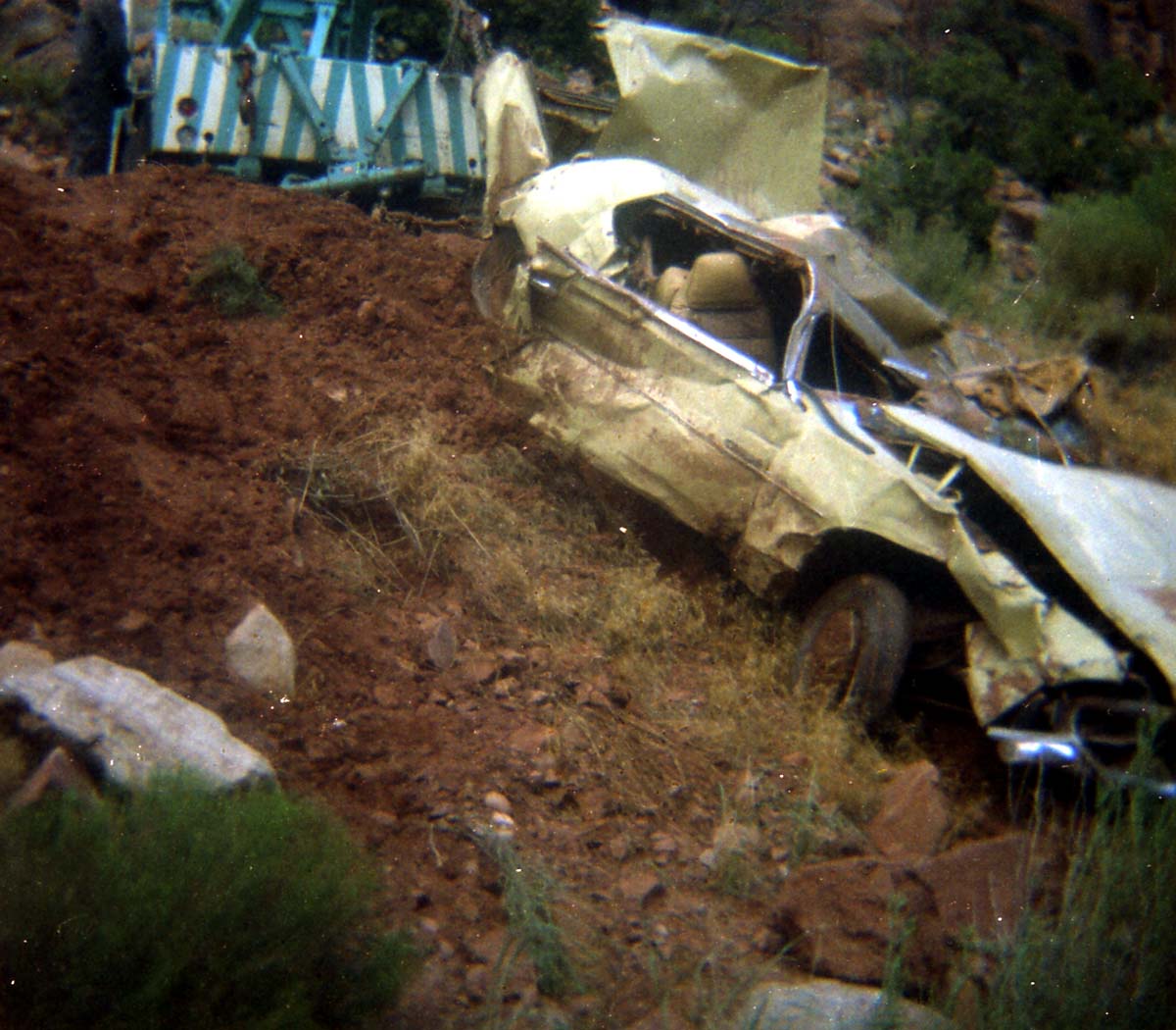 Color photos of park personnel removing a car from the flood waters of the 1975 flood.