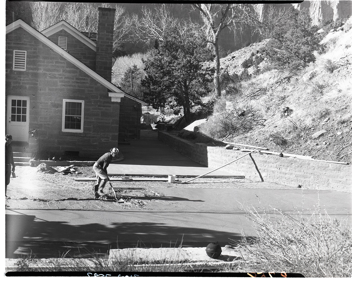Workers pouring concrete at the ranger dormitory parking area.