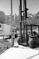 Workers operating a life machine during construction of headquarters addition.