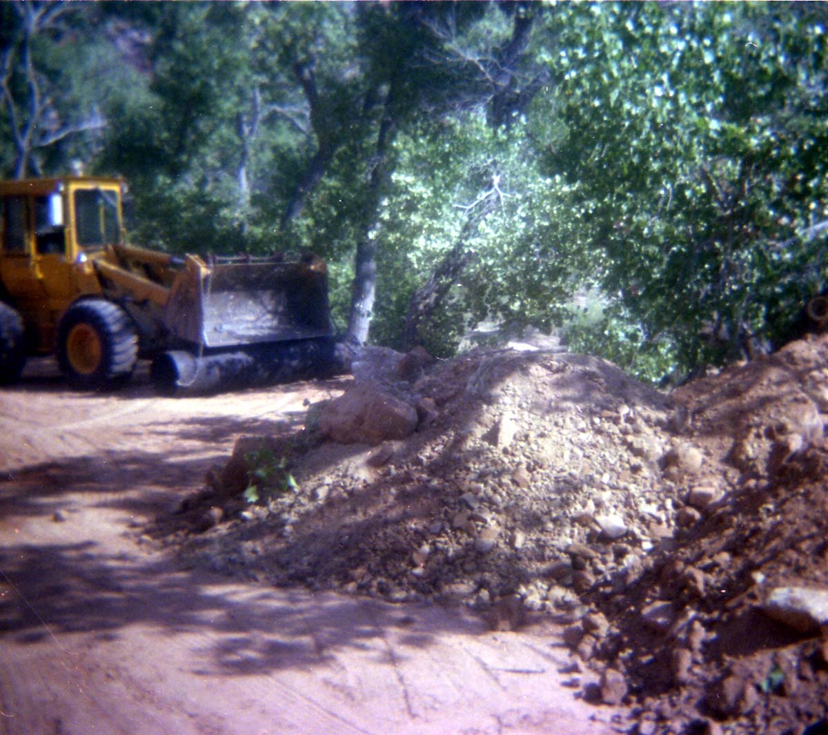 Color Photo of a rock slide along road.