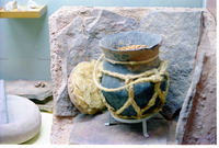 Color photos of prehistoric jar (North Creek Gray) display.