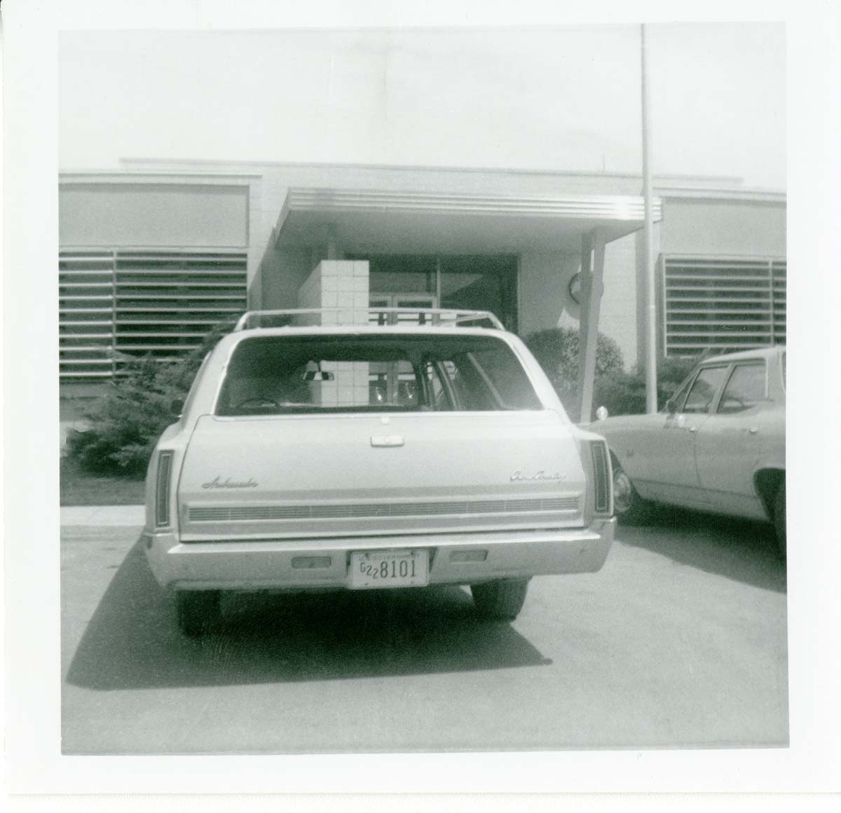 Vehicle parked in parking lot of the old Mission 66 Visitor Center and Museum.