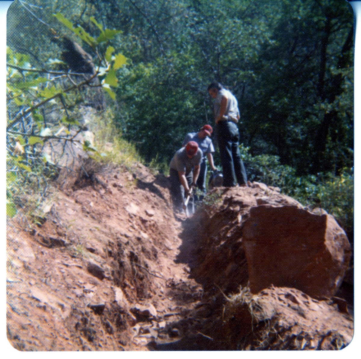 Workers excavating ditch.