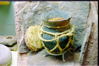 Color photos of prehistoric jar (North Creek Gray) display.
