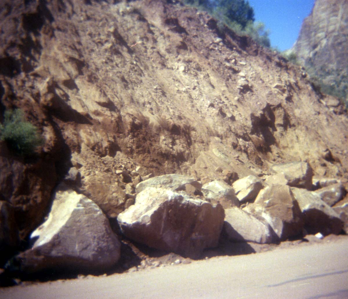 Color Photo of a rock slide along road.