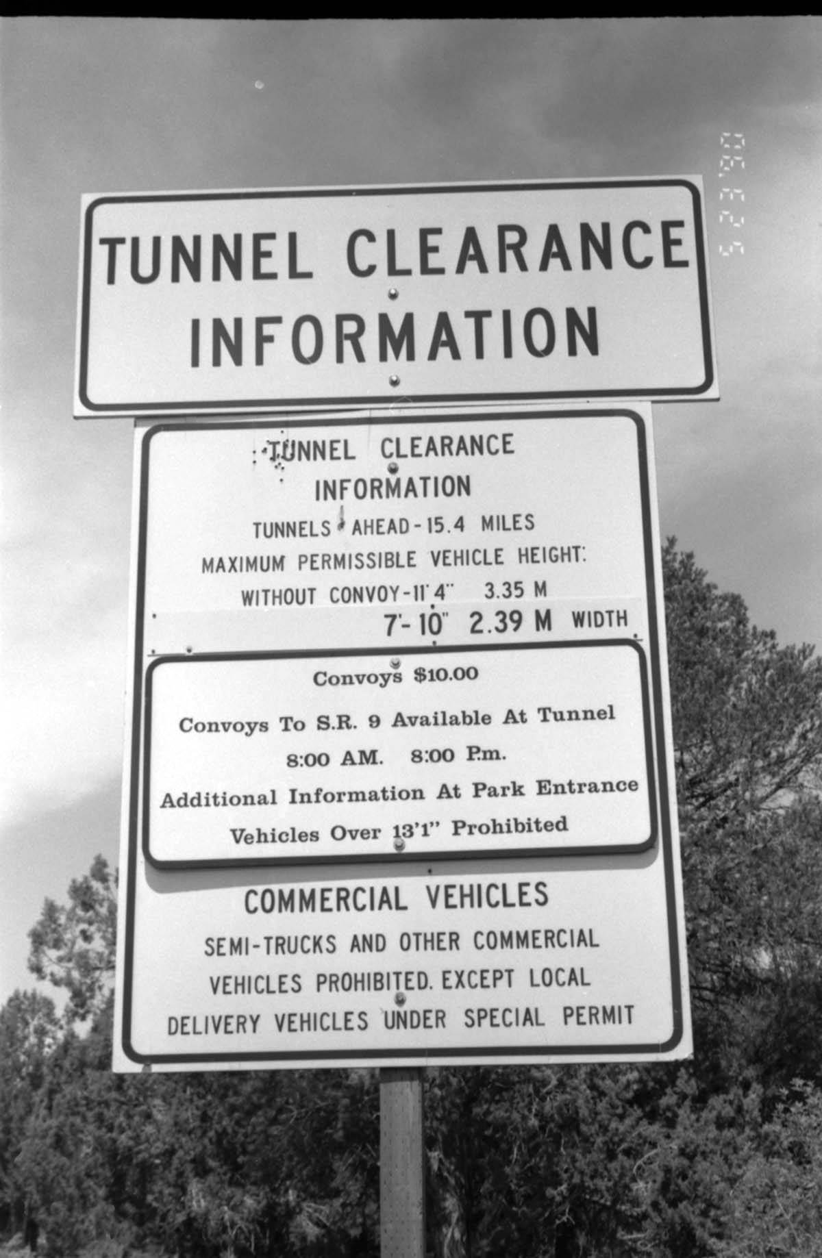 Close up of 'Tunnel Clearance Information' sign during construction of headquarters addition.