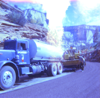 Man inspecting chipsealing job being performed on the roads.