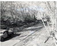 Road construction near new Oak Creek bridge, stone rip rap at gutter.