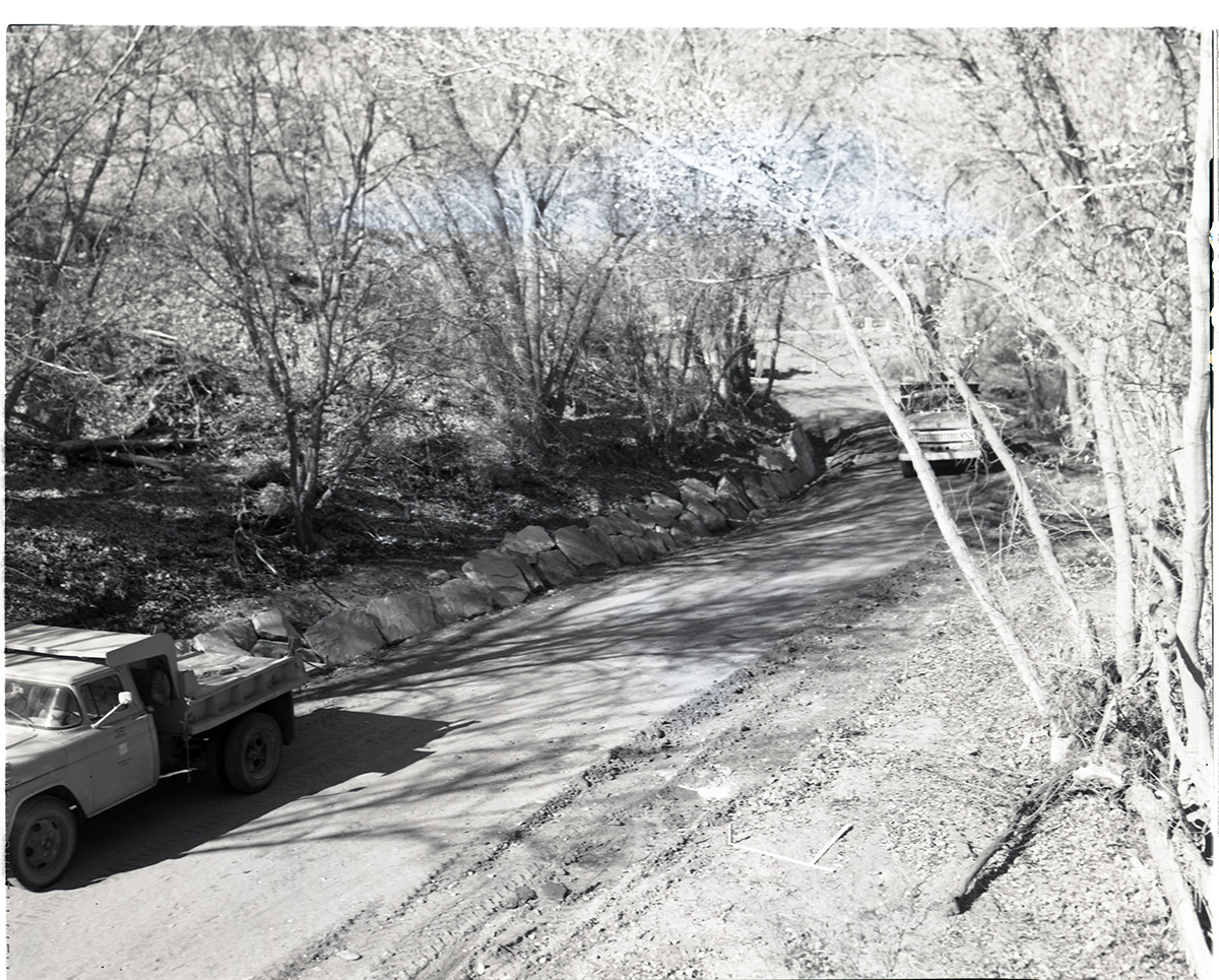 Road construction near new Oak Creek bridge, stone rip rap at gutter.