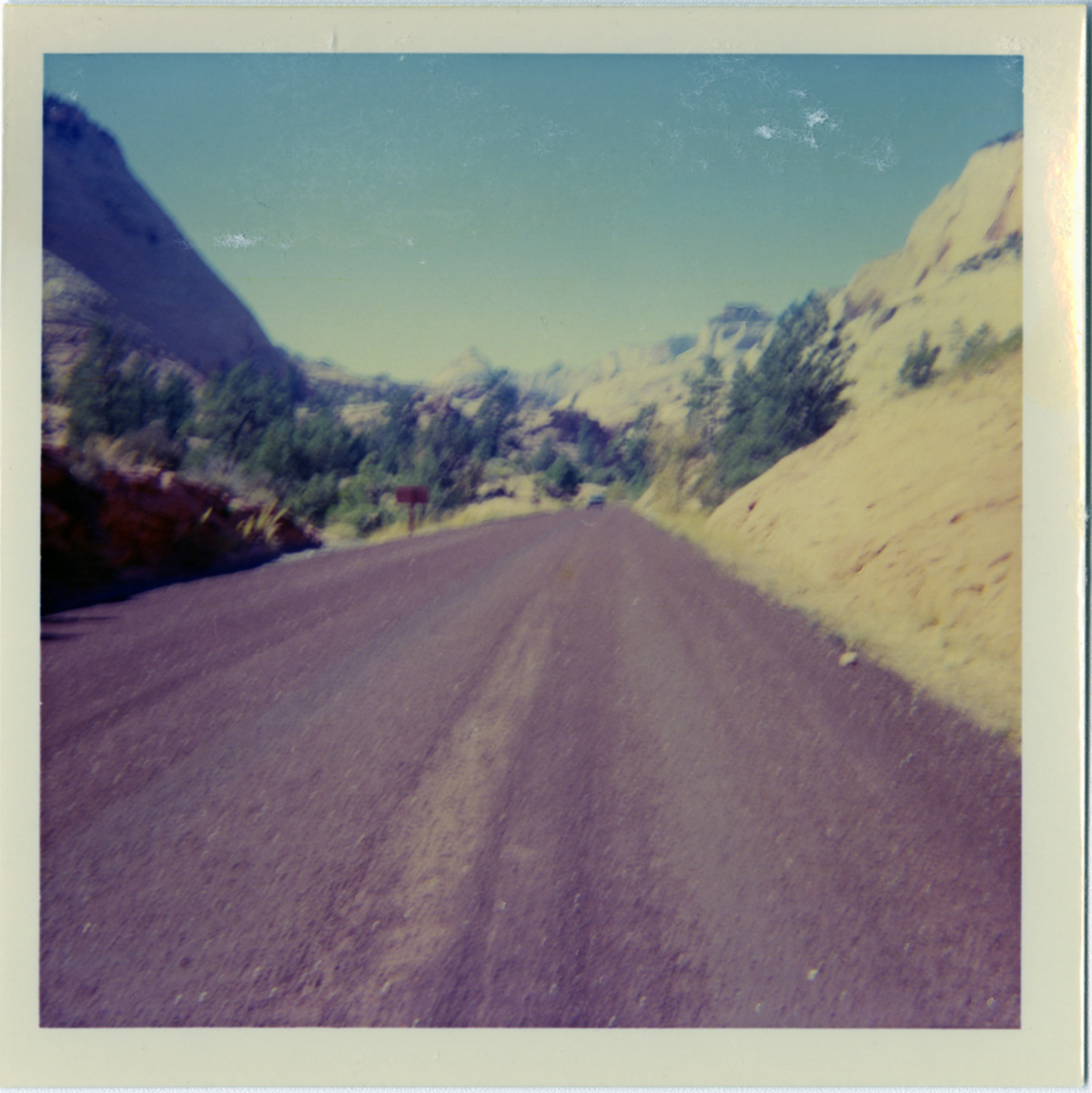 Road with surrounding landscape during chipsealing of Zion roads.