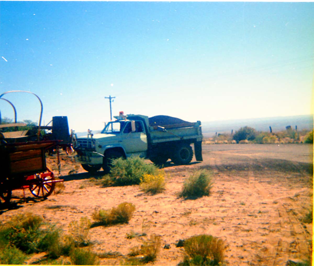 Color Photos of workers chip sealing the parking lot at Pipe Spring.