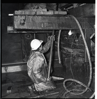 Worker works with drill rig during test hole drilling in Zion-Mt. Carmel tunnel.