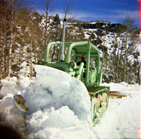 Color Photos of the parks snowplow/ tractor.