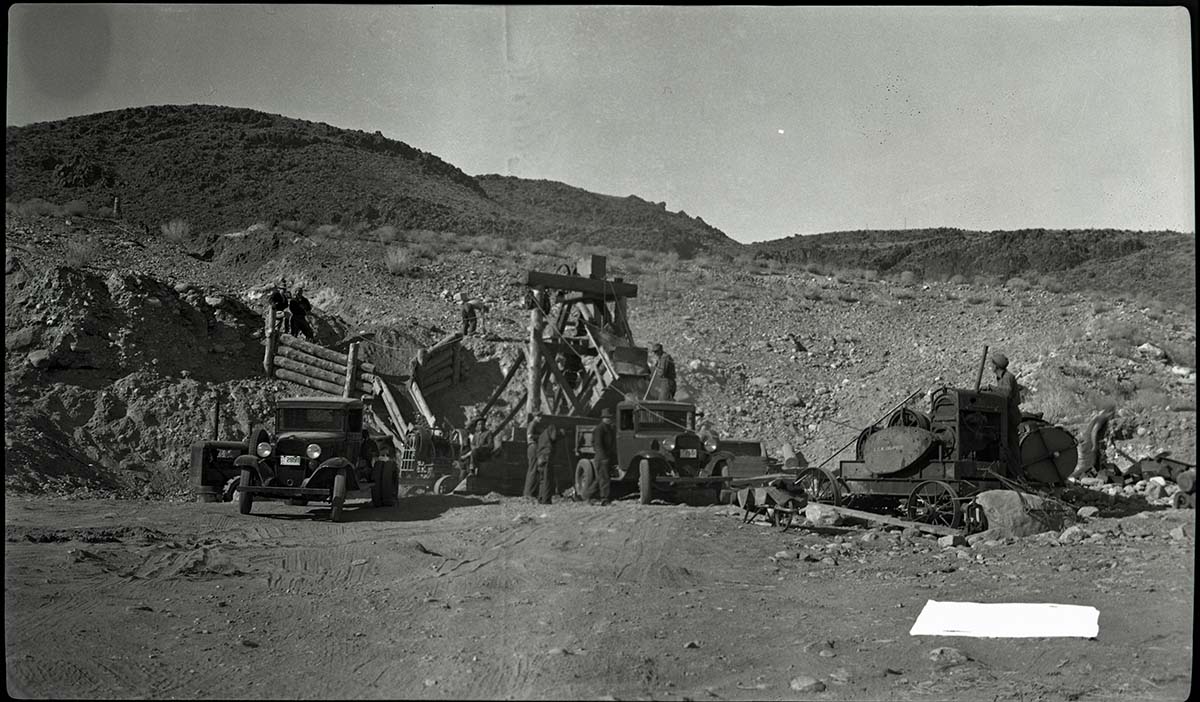 157 gravel plant at NP 4. Men operating machinery to load truck.