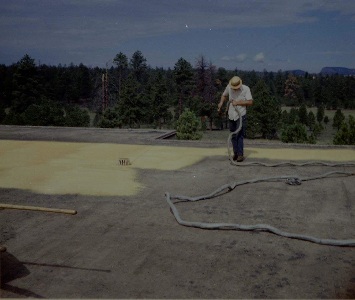 Man spraying foam sealant during reroofing project. Bryce Canyon National Park.