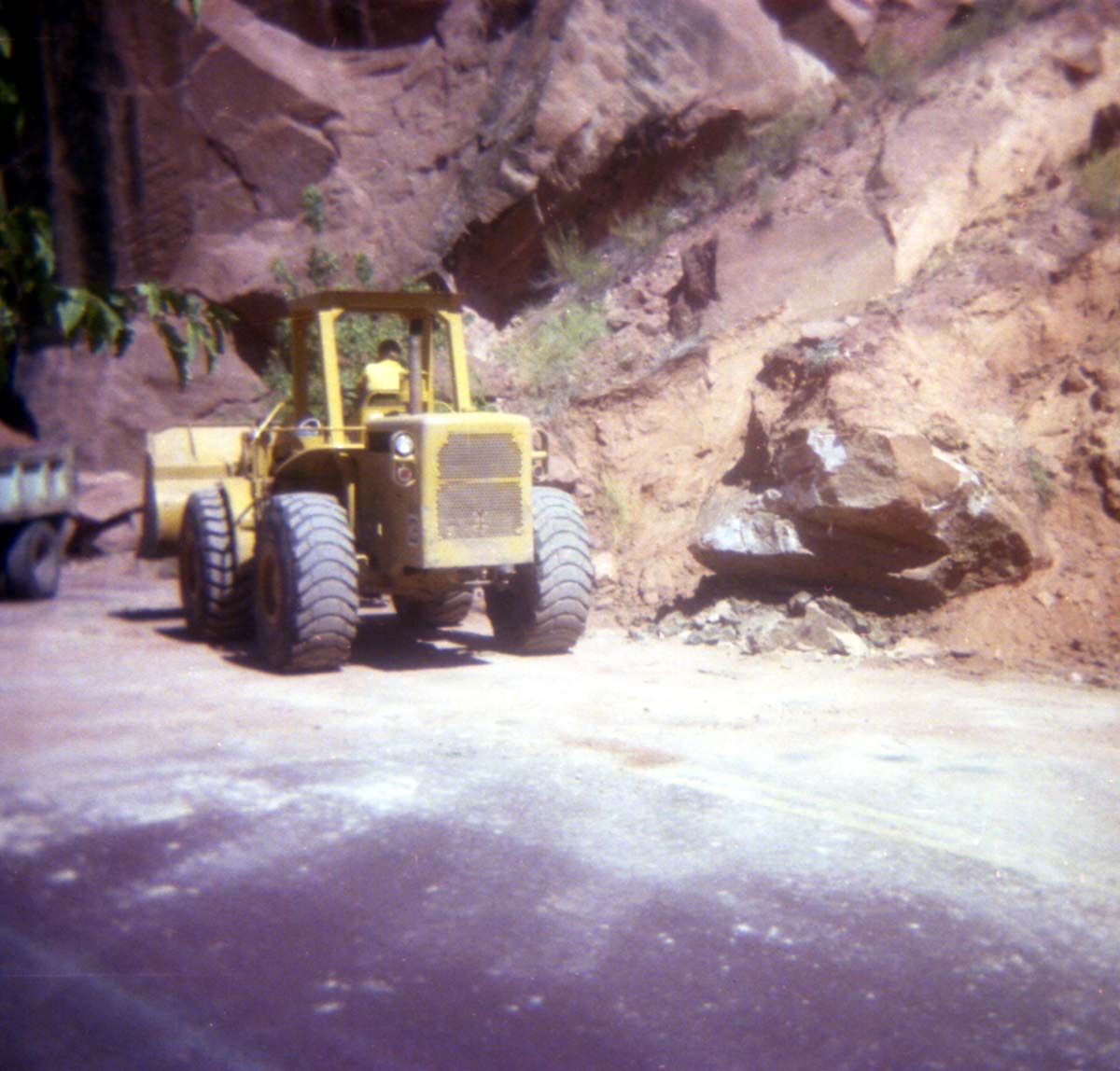 Color Photo of a rock slide along road.