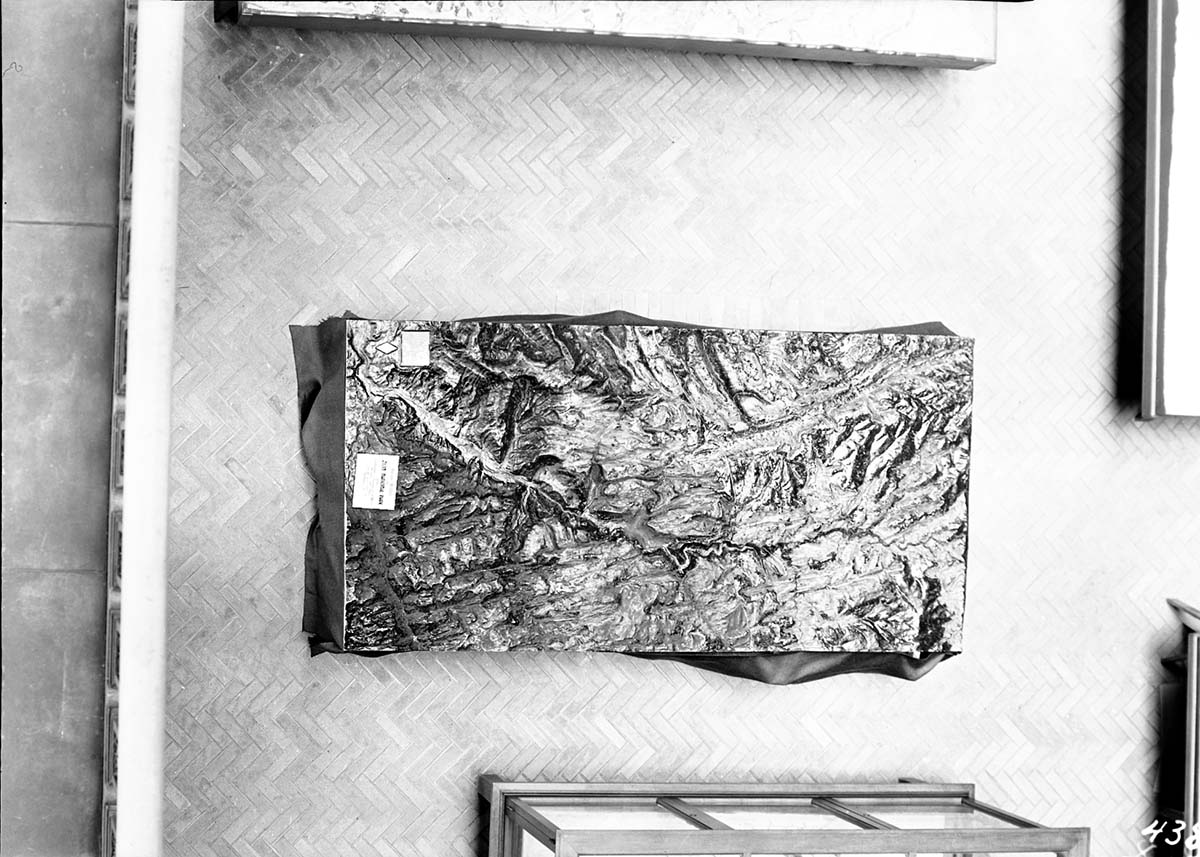 Telephoto from the third floor of the University of California Berkeley Hearst Memorial Mining Building, showing Zion National Park relief map. Herringbone-patterned brick flooring.