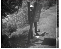 BW Photo of a rock slide along Route 2 - 110mm. Sign damage.