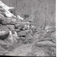 Two rangers viewing the damage on the trail and rock work on the Weeping Rock Trail.