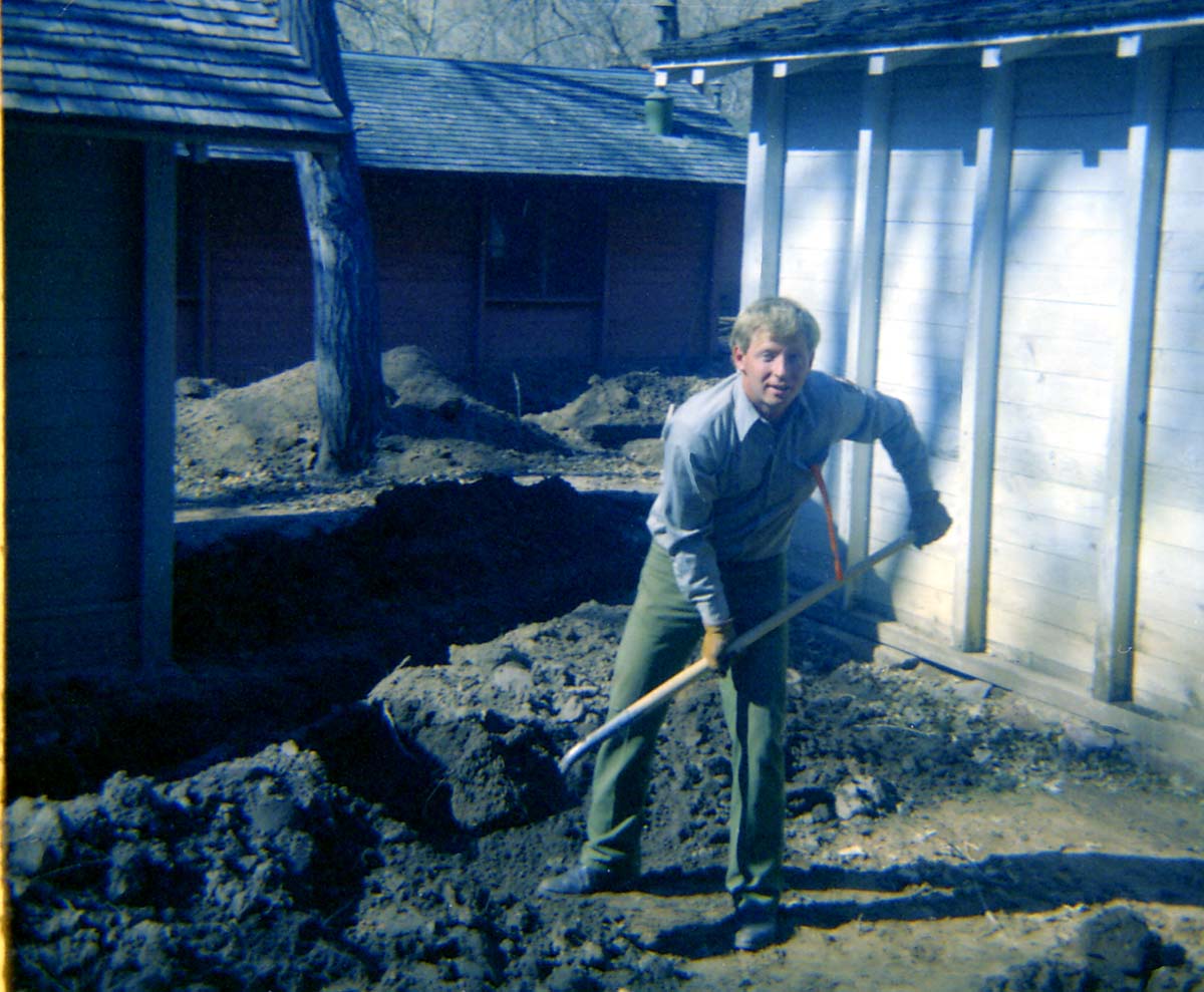 Man shoveling dirt during the utilities project at Zion Lodge.