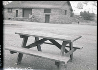 Old type (wooden) campground picnic tables in utility area.