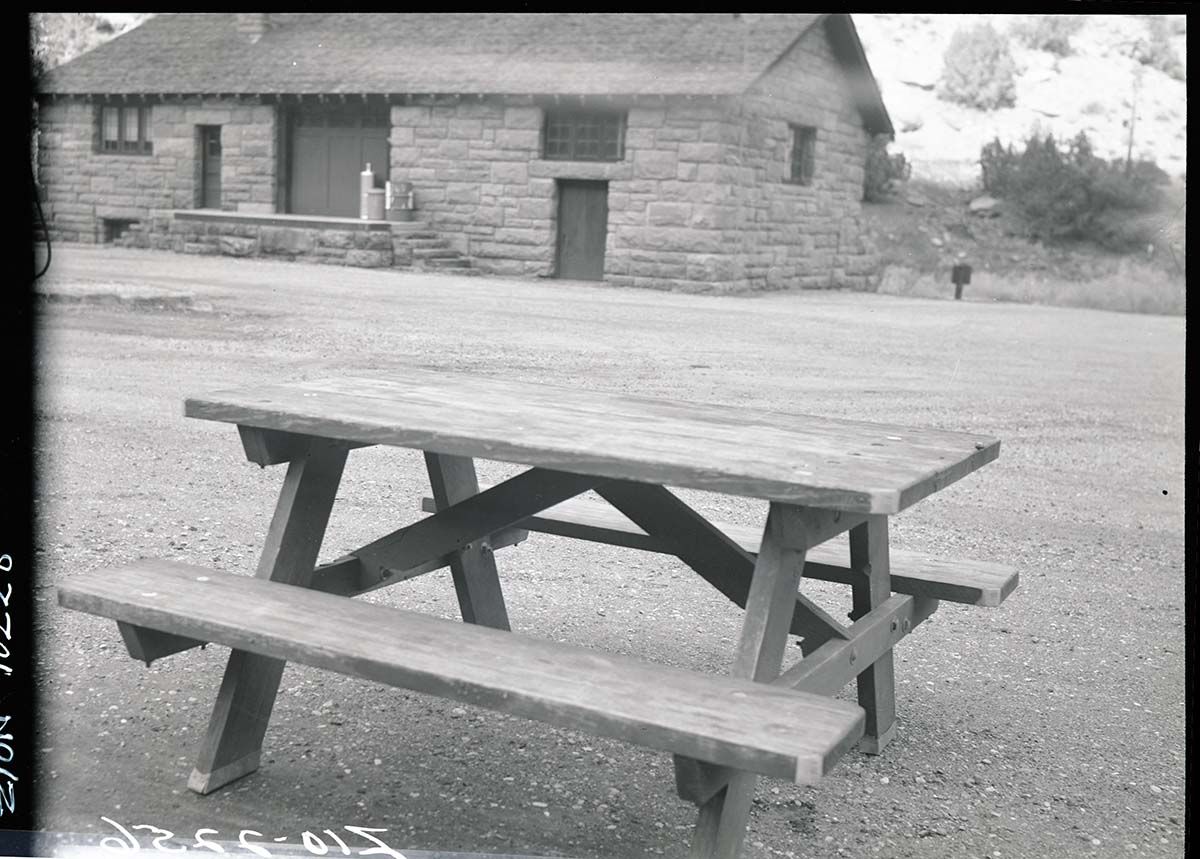 Old type (wooden) campground picnic tables in utility area.