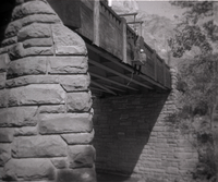 Men working on side of Canyon Junction vehicle bridge.
