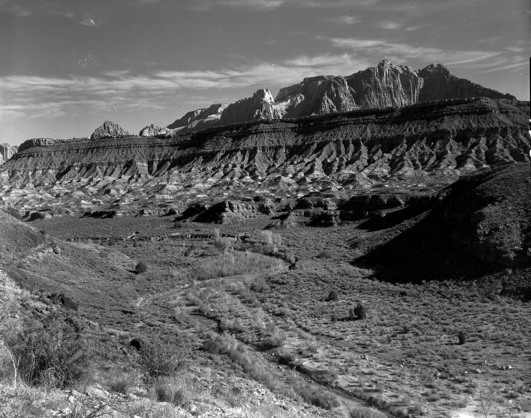 Erosion on the benches south of Rockville. Mukuntuweap and West Temple in the background.