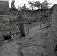 Men working on repairing retaining wall along East Rim road.