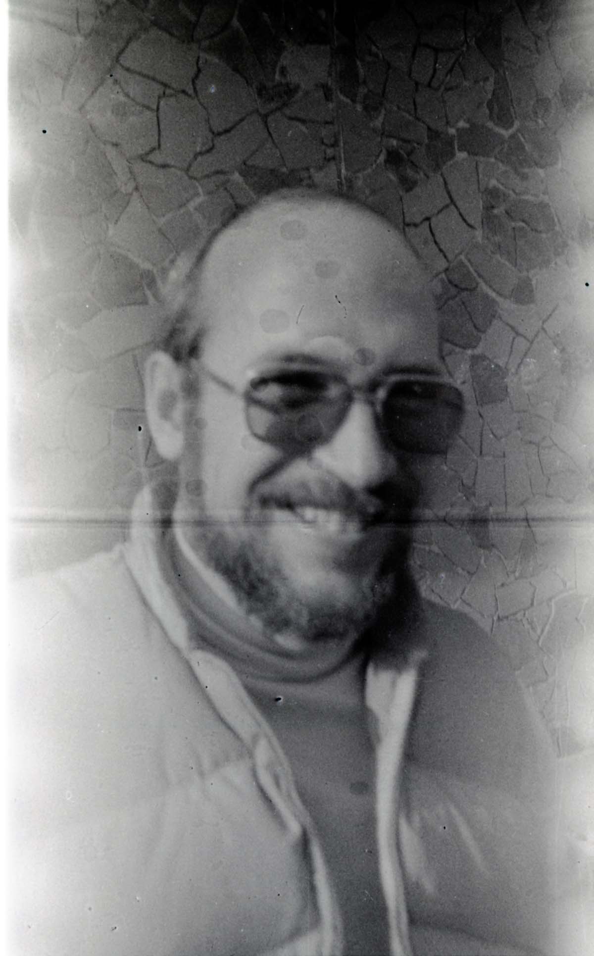 Man with beard smiling.