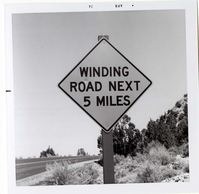 Road sign reading 'Winding Road Next 5 Miles' in Kolob Canyon.