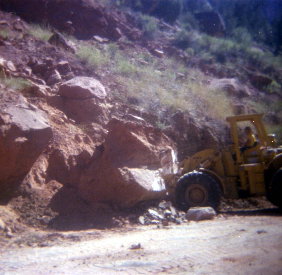 Color Photo of a rock slide along road.