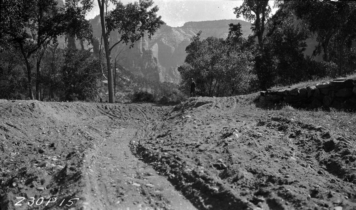 Channel change #2 before turning river through. New Civilian Conservation Corps (CCC) rock quarry opened up to complete river projects. Man on bank.