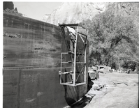 Construction of million gallon water tank at Birch Creek with workmen welding and cleaning inside walls.