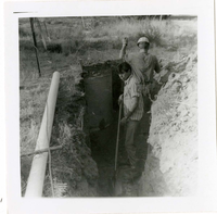 Workers digging ditch during the Watchman housing utility project.