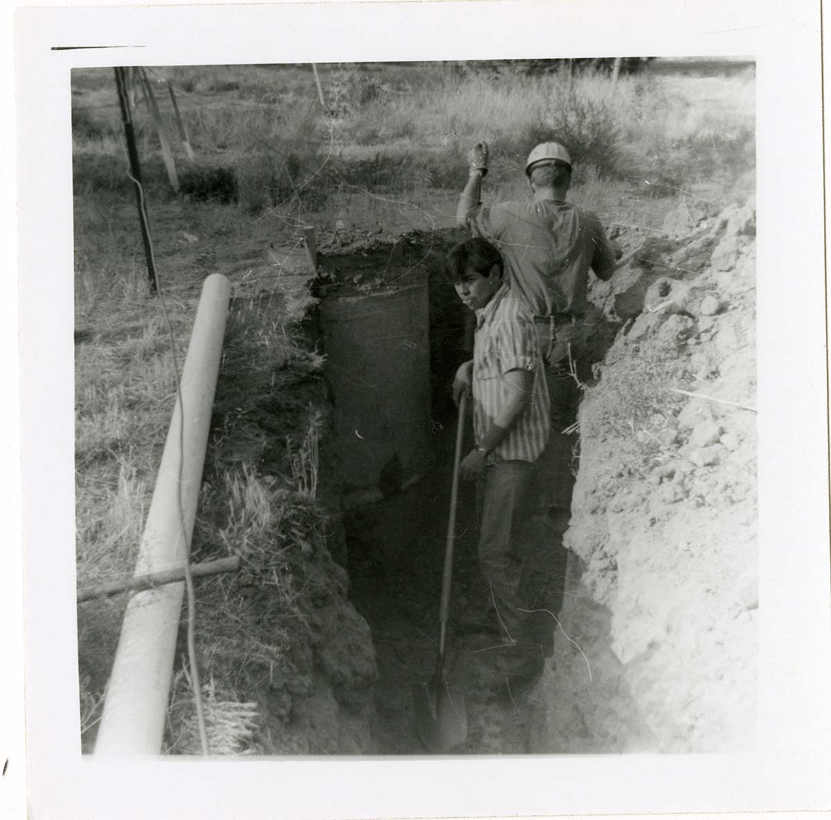 Workers digging ditch during the Watchman housing utility project.