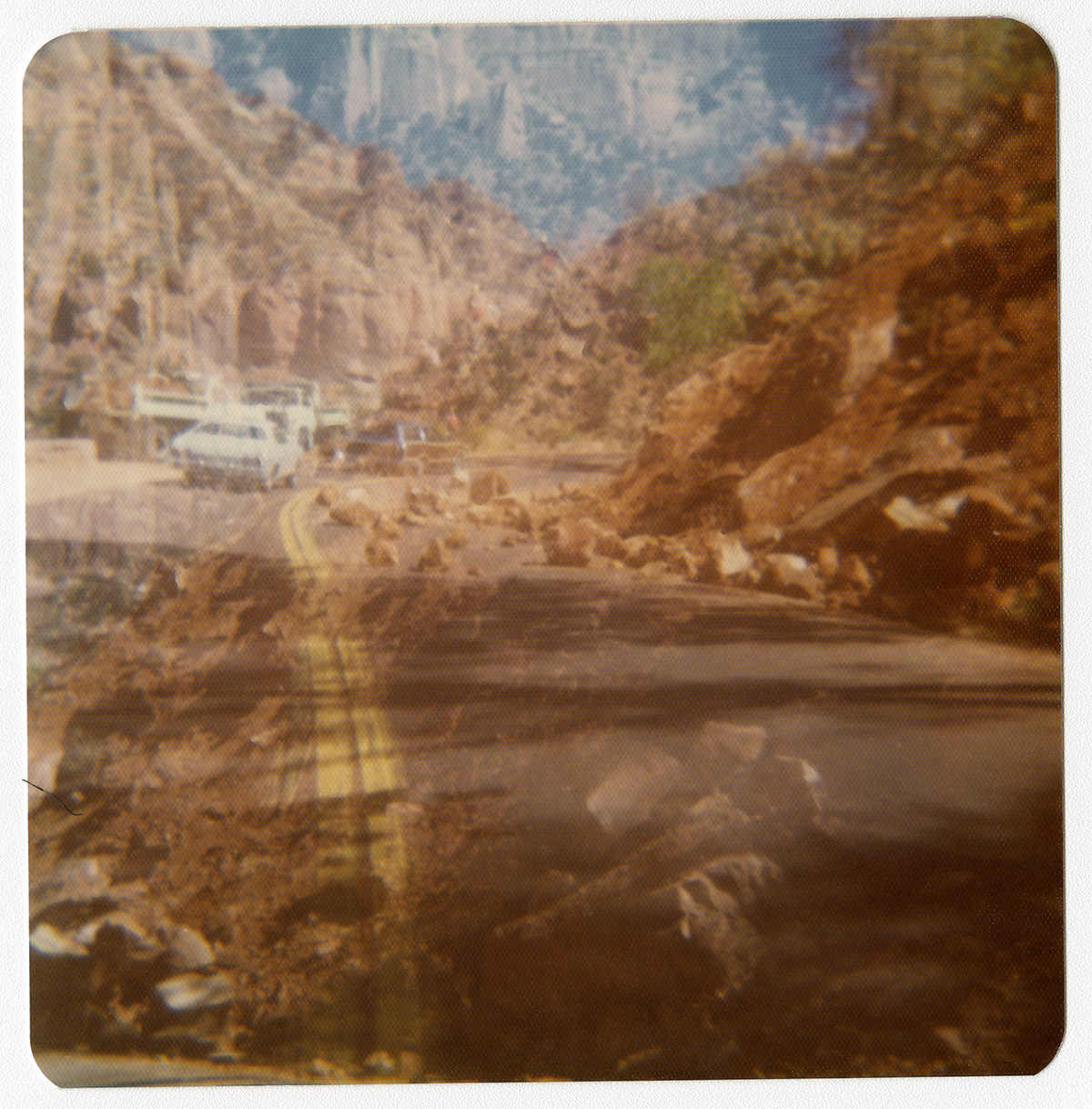 Rocks and cars in road during the widening of the retaining wall along the Zion-Mt. Carmel Highway switchbacks.