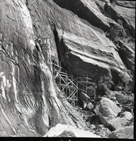 Crews upgrading water system at Temple of Sinawava - scaffolding up cliff face to spring.