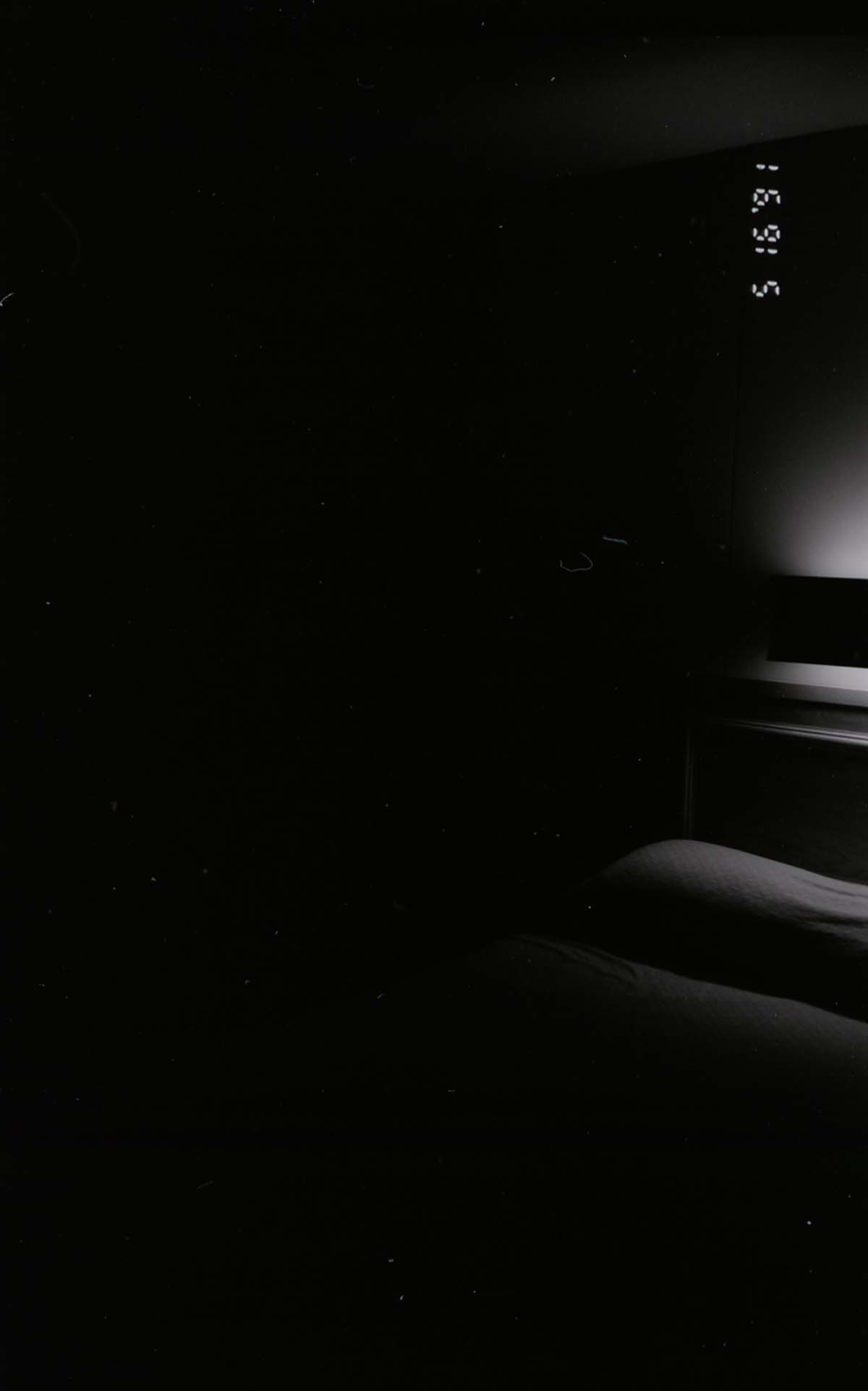 Bed and headboard in barracks. [Image possibly for comparative housing study]