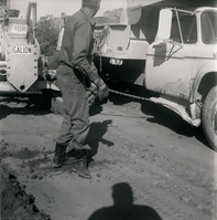 Man working along side construction vehicles during road grading to Chamberlain Ranch and the Narrows.