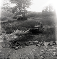 Tractor clearing road of rocks and debris along the scenic canyon drive near the Grotto.