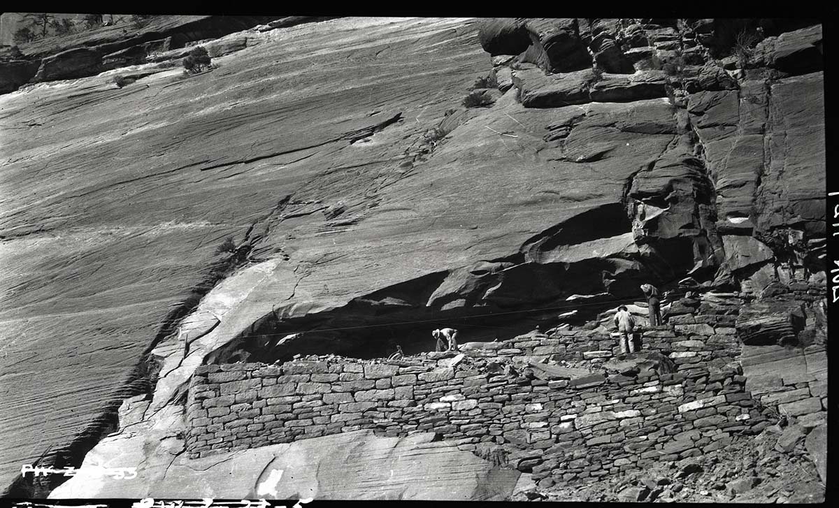 Construction on West Rim Trail with masons and laborers working on switchbacks.