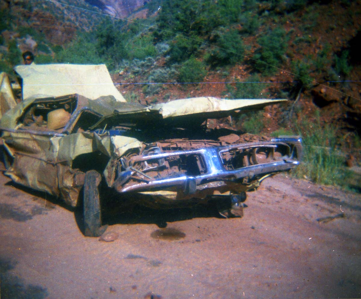 Color photos of park personnel removing a car from the flood waters of the 1975 flood.