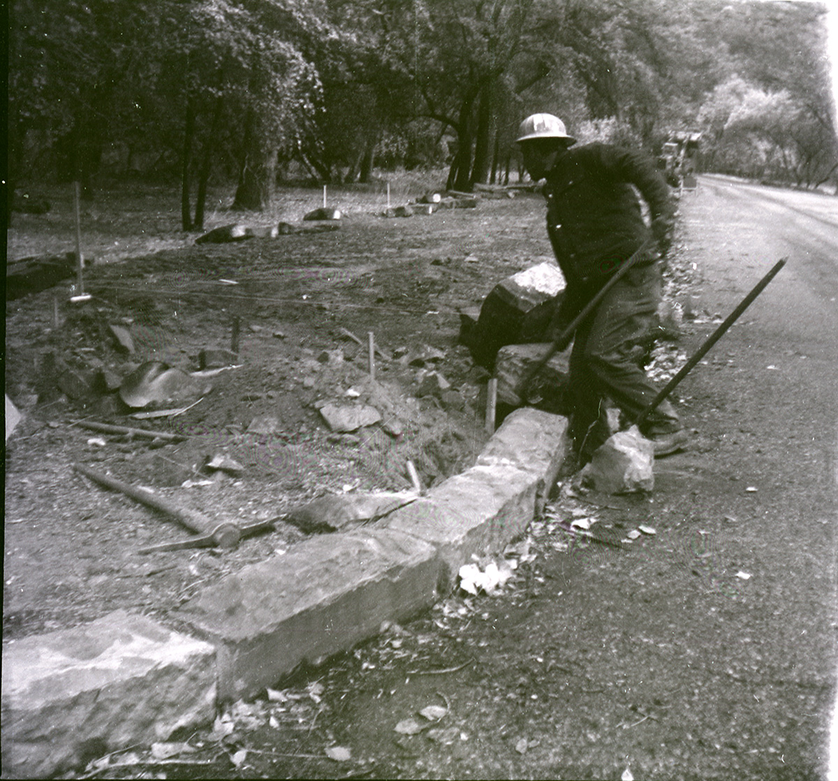 Man working on road construction along the scenic canyon drive near the Grotto.