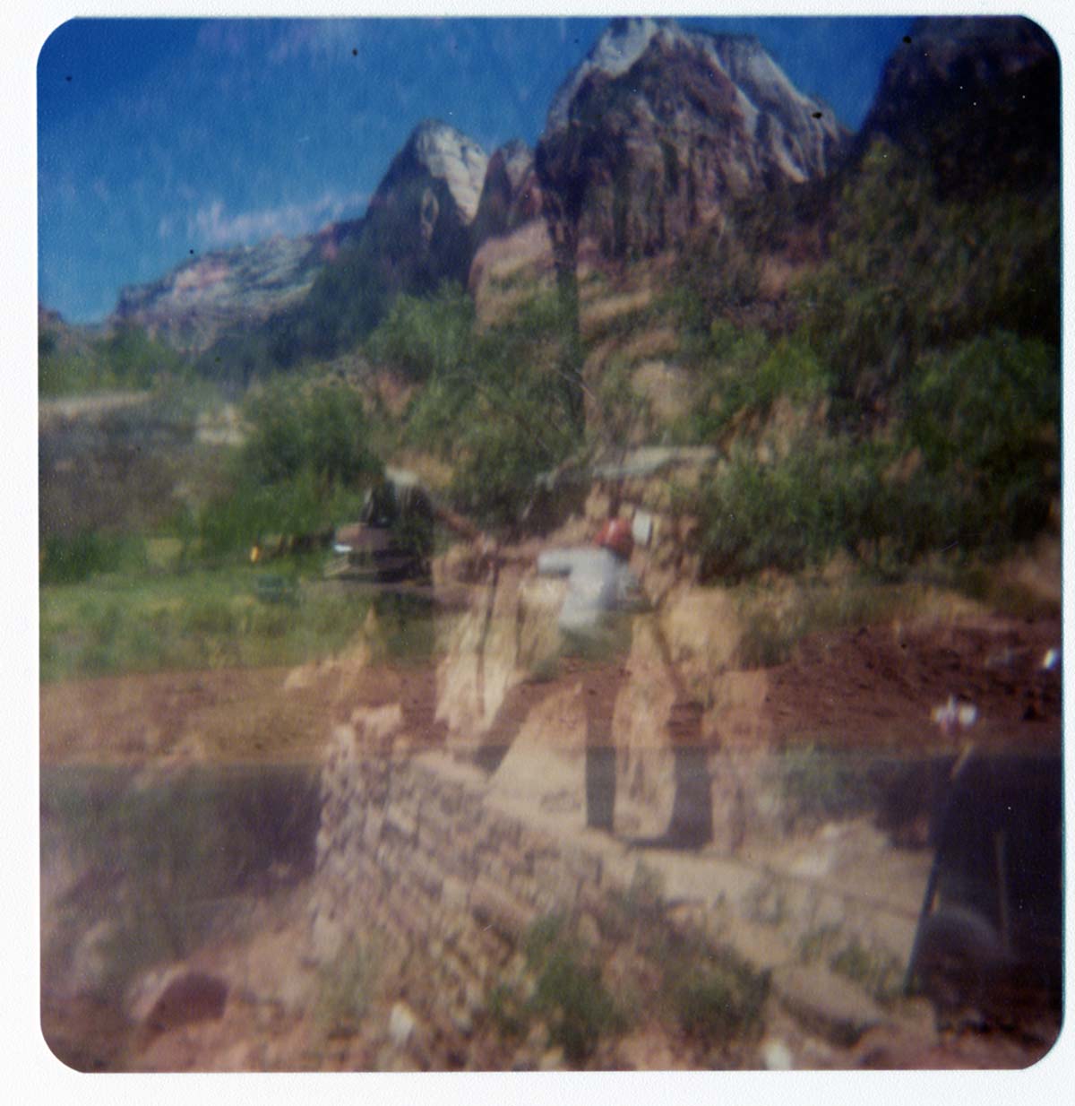Two men working on the cables for pulley system to move new Grotto footbridge across the Virgin River.